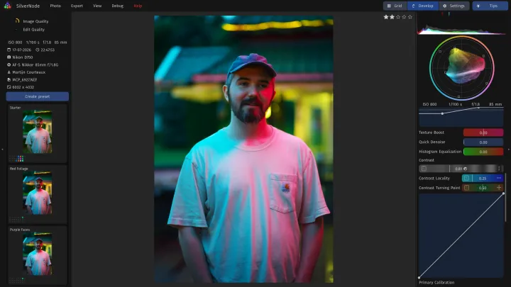 Developing a portrait of a bearded man in a cap, lit in pink and cyan neon, with the contrast sliders and their curve.